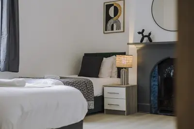 a bedroom with a bed and a fireplace at Onslow House - Air Host & Stay - 5 bed, Sleeps 14 in Liverpool
