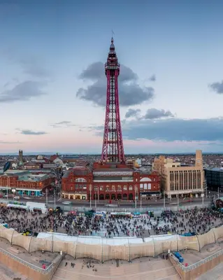 a crowd of people in front of the eiffel tower at Reads Avenue 1 Bed Apartment - Next To H&A Social Club - Minutes from Winter Gardens & Town Centre! in Blackpool