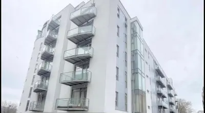 a white building with balconies on the side of it at Modern City Centre Apartment in Liverpool
