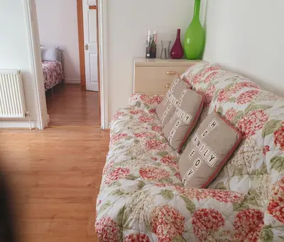 a couch with pillows on it in a living room at Holiday flat first floor in Blackpool