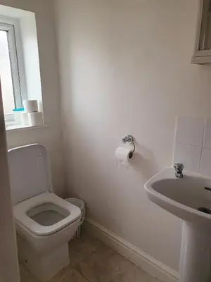 a white bathroom with a toilet and a sink at Holiday flat first floor in Blackpool