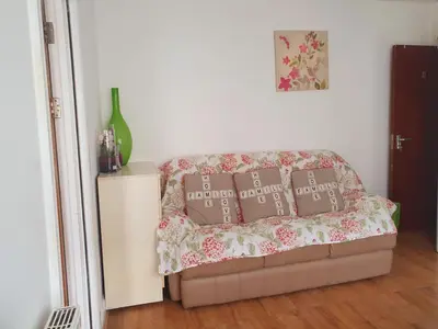 a couch with four pillows on it in a room at Holiday flat first floor in Blackpool
