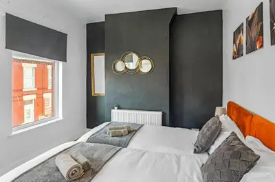 a bedroom with a large bed and a window at Modern 2-Bedroom Contractor House with 4 Beds, Free Parking, High-Speed Wi-Fi in Seacombe