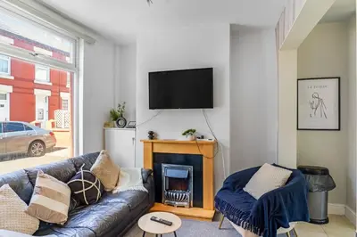 a living room with a couch and a fireplace at Modern 2-Bedroom Contractor House with 4 Beds, Free Parking, High-Speed Wi-Fi in Seacombe