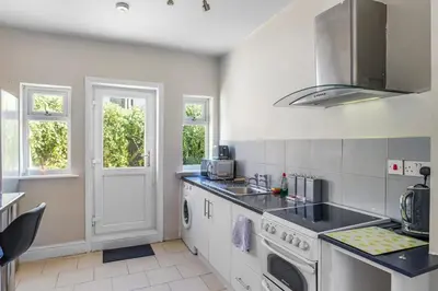 a kitchen with a sink and a stove at Modern 2-Bedroom Contractor House with 4 Beds, Free Parking, High-Speed Wi-Fi in Seacombe