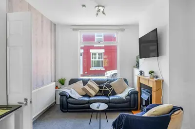 a living room with a couch and a television at Modern 2-Bedroom Contractor House with 4 Beds, Free Parking, High-Speed Wi-Fi in Seacombe