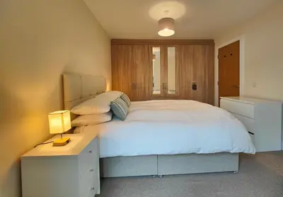 a bedroom with a large white bed and a desk at 2-Bedroom Flat Near River Lune in Halton