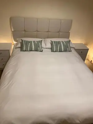 a large white bed with two pillows on it at 2-Bedroom Flat Near River Lune in Halton