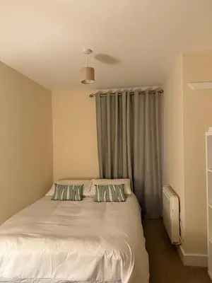 a bedroom with a bed with two pillows at 2-Bedroom Flat Near River Lune in Halton