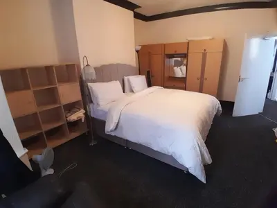 a bedroom with a large bed with white sheets at Modern Seaside Stay at Bela Grove-Sleeps8 in Blackpool