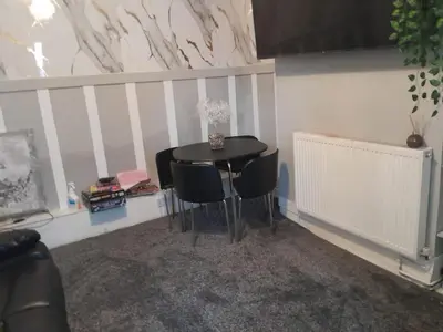 a dining room with a table and chairs at Modern Seaside Stay at Bela Grove-Sleeps8 in Blackpool