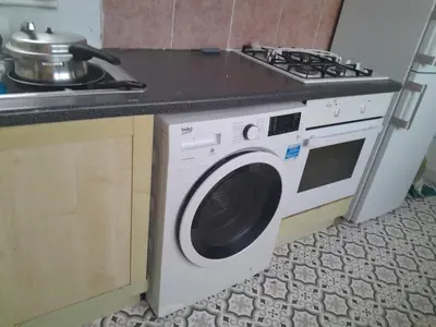 a washing machine in a kitchen next to a stove at Modern Seaside Stay at Bela Grove-Sleeps8 in Blackpool