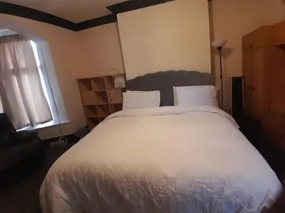 a bedroom with a large white bed and a window at Modern Seaside Stay at Bela Grove-Sleeps8 in Blackpool