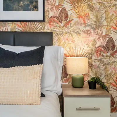 a bedroom with a bed with a table with a lamp at Birkenhead Haven - Sleeps 14 - Family and Group Stay in Birkenhead