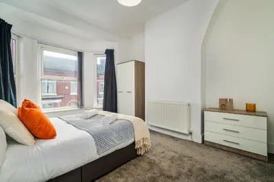 a bedroom with a bed and a window at Birkenhead Haven - Sleeps 14 - Family and Group Stay in Birkenhead