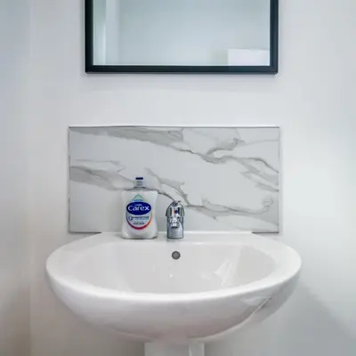 a bathroom sink with a bottle of toothpaste on it at Birkenhead Haven - Sleeps 14 - Family and Group Stay in Birkenhead