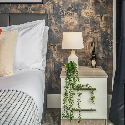 a bedroom with a bed and a table with a lamp at Birkenhead Haven - Sleeps 14 - Family and Group Stay in Birkenhead