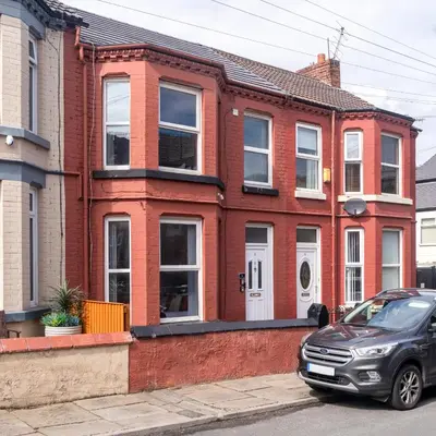 a car parked in front of a red brick house at Birkenhead Haven - Sleeps 14 - Family and Group Stay in Birkenhead