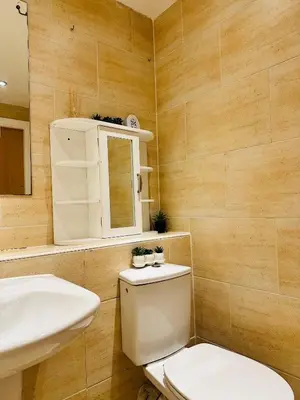 a bathroom with a toilet and a sink at 2 Bedroom City Centre Apartment Free Secure Parking in Liverpool