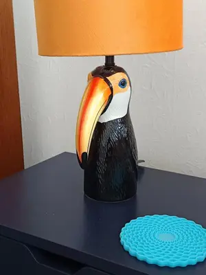 a statue of a toucan on a table with a lamp at Rosemount Guest Suite in Grange Over Sands