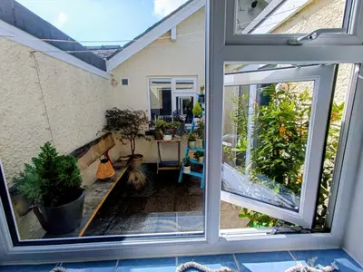 an open sliding glass door of a patio with a table at Rosemount Guest Suite in Grange Over Sands