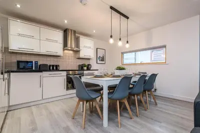 a kitchen and dining room with a table and chairs at Spacious City Centre 2 Beds 2 baths Sleeps 10 in Liverpool