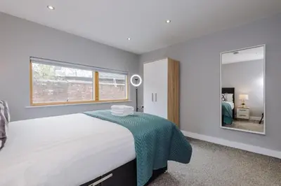 a bedroom with a large bed and a large mirror at Spacious City Centre 2 Beds 2 baths Sleeps 10 in Liverpool
