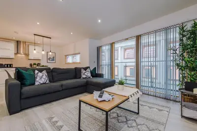 a living room with a couch and a table at Spacious City Centre 2 Beds 2 baths Sleeps 10 in Liverpool