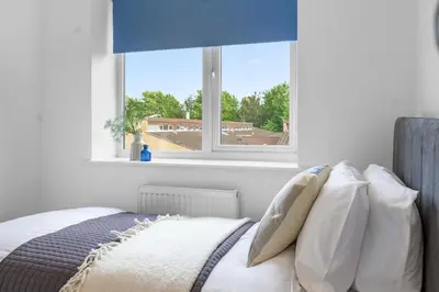 a bedroom with a bed with a large window at Quiet St Helens Home Near Train Station, Free Parking and WiFi in Saint Helens
