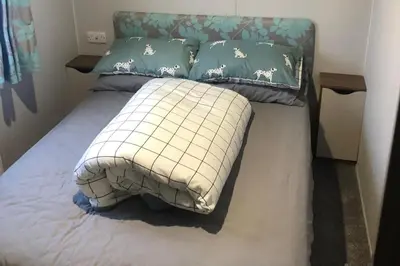 a bed in a room with two pillows on it at Seaside Retreat in Fleetwood in Fleetwood
