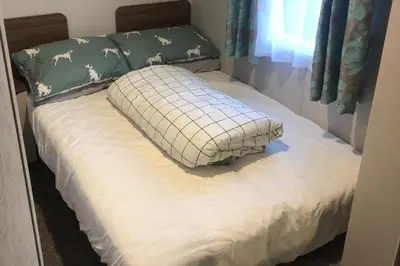 a bed with a pillow on top of it at Seaside Retreat in Fleetwood in Fleetwood