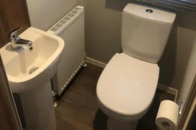 a bathroom with a white toilet and a sink at Seaside Retreat in Fleetwood in Fleetwood