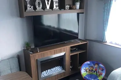 a living room with a large flat screen tv at Seaside Retreat in Fleetwood in Fleetwood
