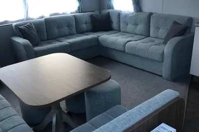 a living room with a couch and a table at Seaside Retreat in Fleetwood in Fleetwood