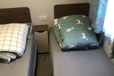 two twin beds in a room at Seaside Retreat in Fleetwood in Fleetwood