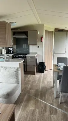 a kitchen and dining room with a table and chairs at Heysham Coastal Escape Family 3-Bed Caravan in Heysham