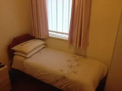 a small bedroom with a bed with a window at Bel Reve Hotel in Blackpool