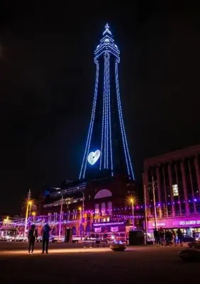 a tower lit up at night with a clock on it at Bel Reve Hotel in Blackpool