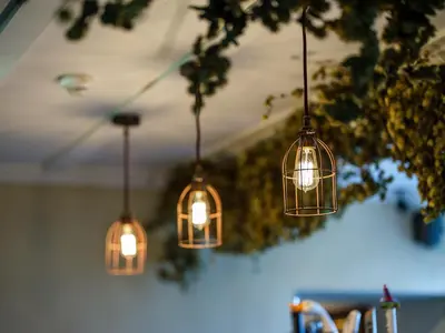 a group of lights hanging from a ceiling at The Wheatsheaf at Beetham in Sandside