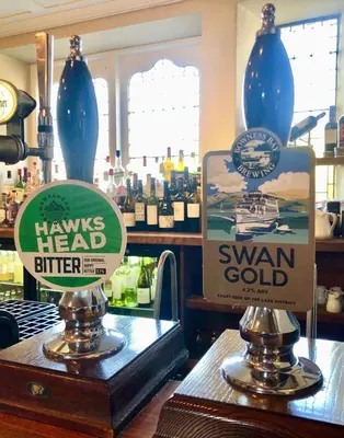 a couple of signs on a counter in a store at The Wheatsheaf at Beetham in Sandside