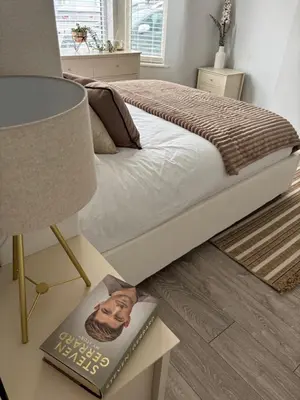 a bedroom with a bed with a lamp and a book at Liverpool Escape - 5 min walk to LFC Stadium, Sleeps 8, free parking, newly renovated home in Liverpool