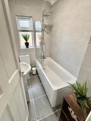 a white bathroom with a tub and a sink at Liverpool Escape - 5 min walk to LFC Stadium, Sleeps 8, free parking, newly renovated home in Liverpool
