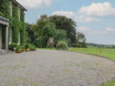 an empty driveway in front of a house at Huntsman's Cottage in Grange Over Sands