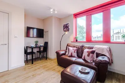 a living room with a couch and a table at Modern 2BR near Wigan Town Centre in Wigan