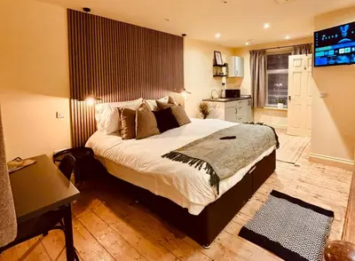 a bedroom with a large bed and a flat screen tv at 8 Parker Street in Lancaster