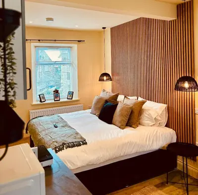 a bedroom with a large bed and a window at 8 Parker Street in Lancaster
