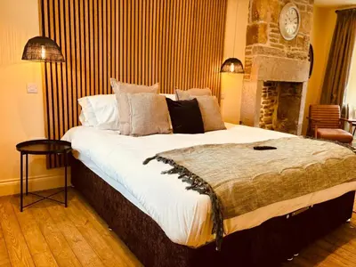 a bedroom with a large bed and a fireplace at 8 Parker Street in Lancaster