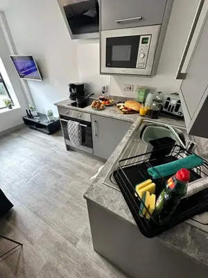 a kitchen with a counter with a tray of food at Modern Duplex Apartment - Liverpool City Centre in Liverpool