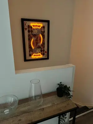 a picture on a wall with a vase on a table at Modern Duplex Apartment - Liverpool City Centre in Liverpool