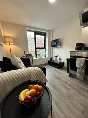 a living room with a bowl of fruit on a table at Modern Duplex Apartment - Liverpool City Centre in Liverpool